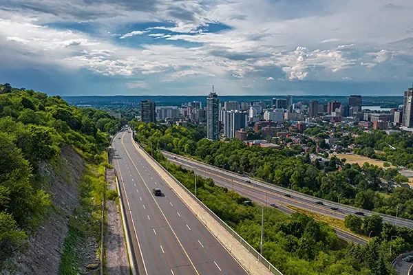 Aerial view of the Hamilton, Ontario skyline with a highway climbing the Niagara Escarpment