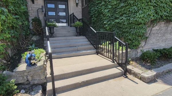 CSIK cleaner maintaining a commercial building entrance in Hamilton